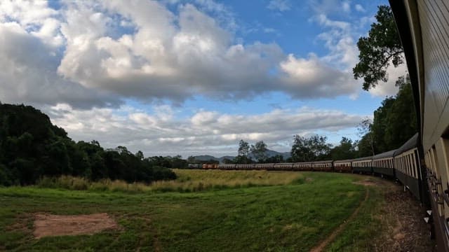 Train traveling through a scenic countryside