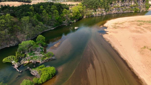 Tranquil river flowing beside rocky cliffs