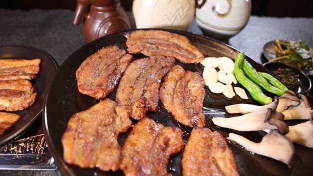 Samgyeopsal and Vegetables Being Grilled on a Hot Pan