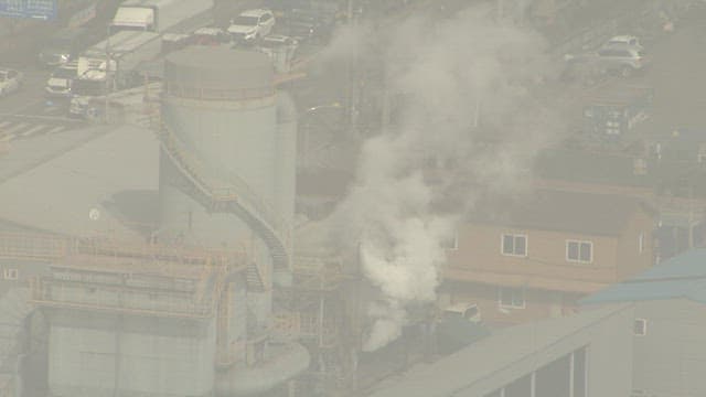 Aerial View of Industrial Complex with Smoke
