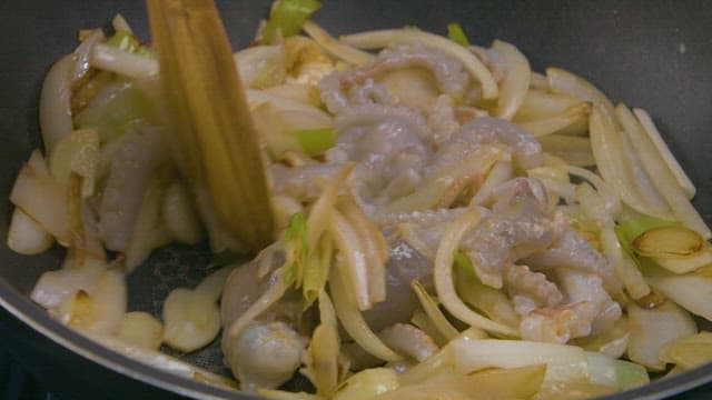 Stir-frying octopus with onions and leeks
