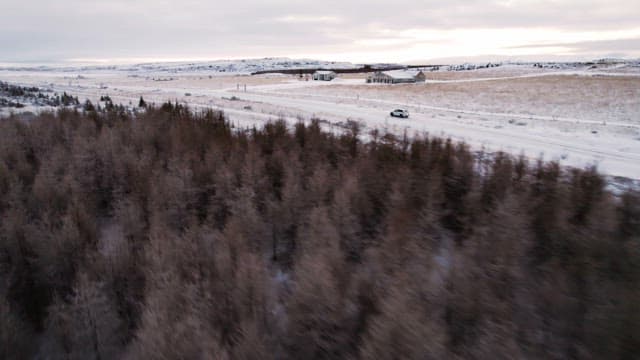 snowy landscape with a car on a road
