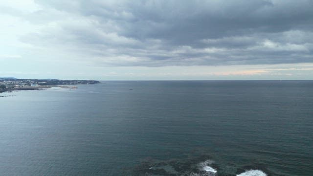 Vast ocean under a cloudy sky