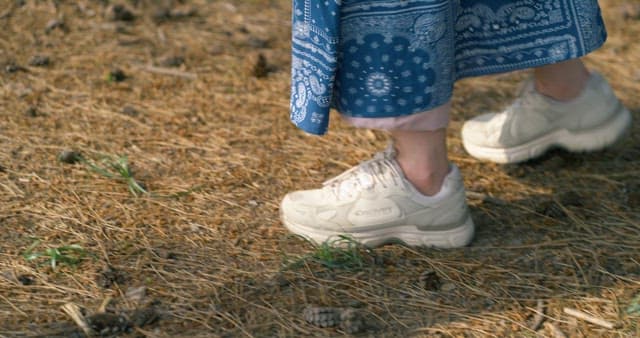 Woman Running on a Dirt Road with a Backpack