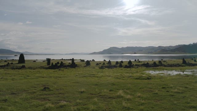 Sunshine Serene Lakeside View with Distant Mountains