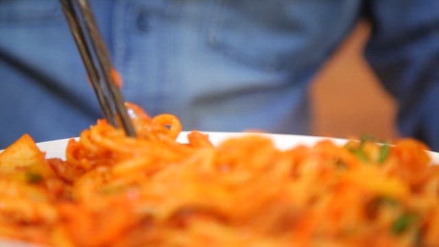 Appetizing and spicy stir-fried jjambbong mixed with chopsticks