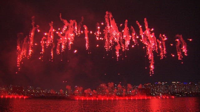 Colorful Fireworks Display Over the City Skyline and River