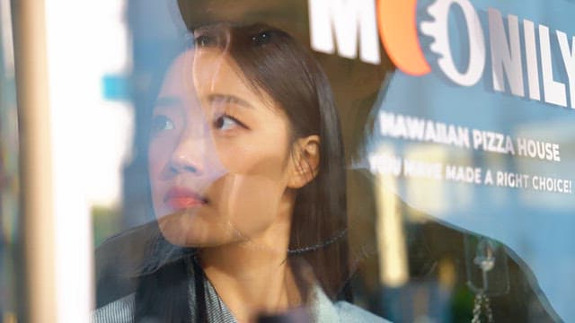 Couple standing across a glass door