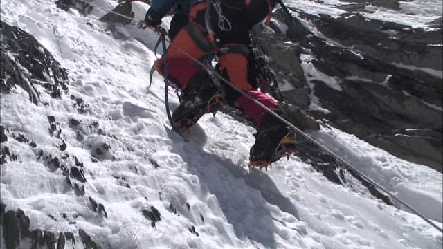 Climbers Ascending Snowy Mountain Slope