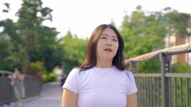 Woman walking on a bridge outdoors