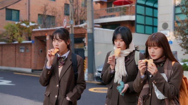 Students eating bungeoppang in winter