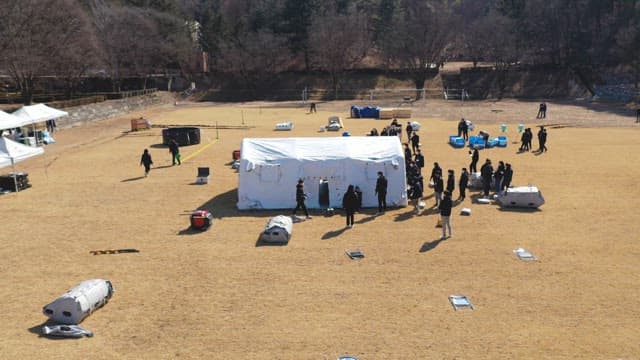 People Working Outdoors with Tents Set Up
