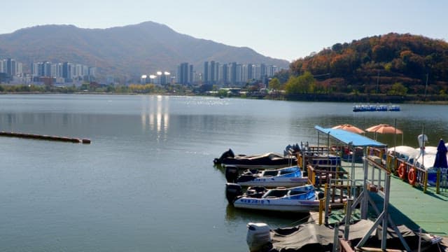 Dcked small boats on a calm Baegunhosu Lake on a sunny day