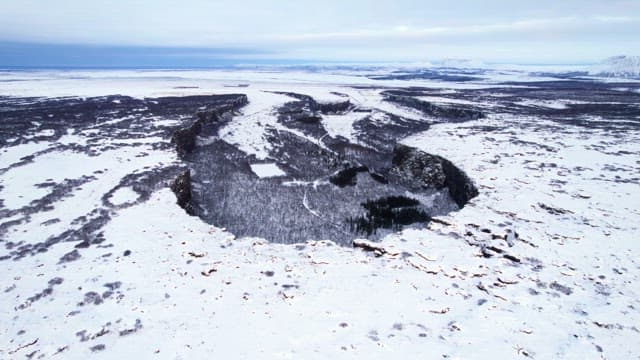 Snow-covered landscape with cliffs