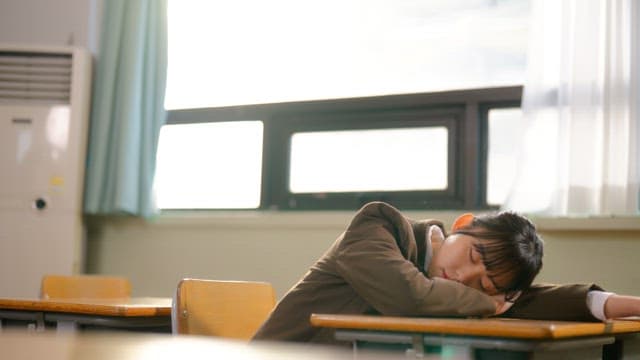 Student resting in a classroom
