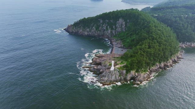 Scenic island with lush greenery and a lighthouse