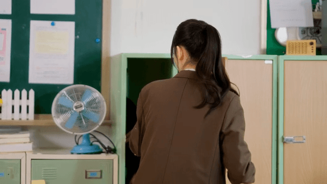 Student putting bag in locker