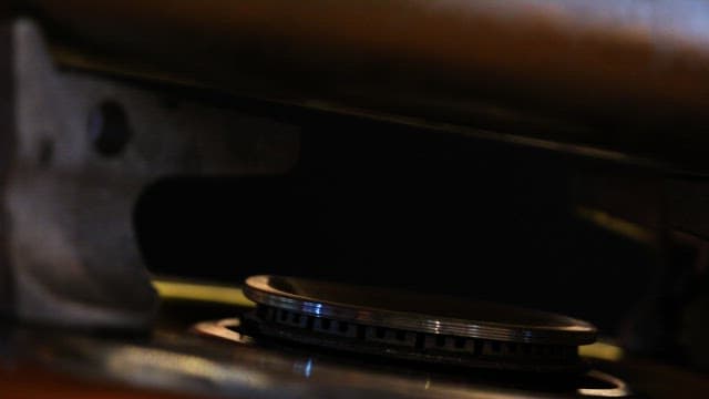 Close-up views of a gas stove burner and Its flame