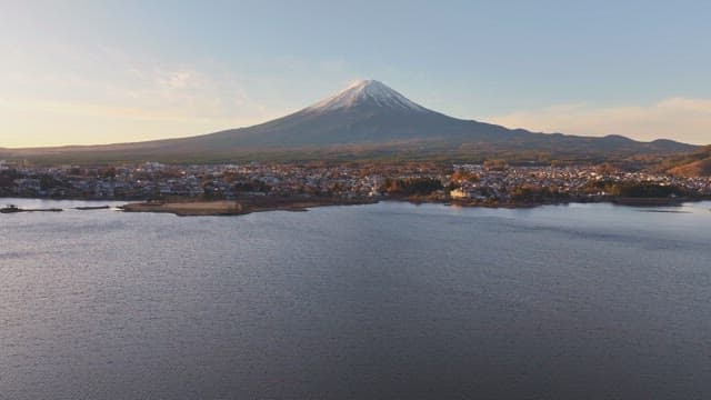 Serene city by a lake with a Mount Fuji