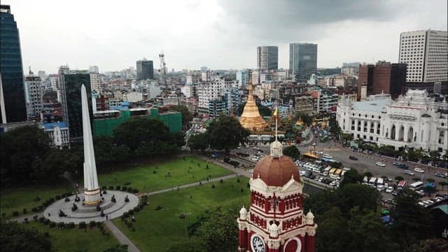 Aerial View of a Bustling City, Yangon with a Golden Pagoda