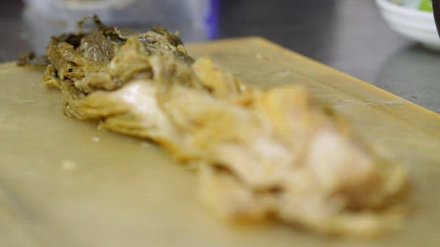 Cutting fermented kimchi on a cutting board