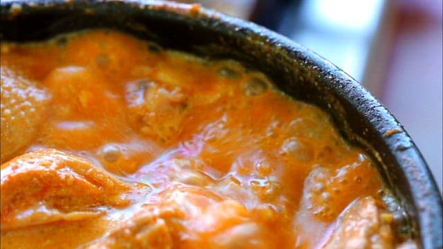 Duck soup boiling in an earthen pot