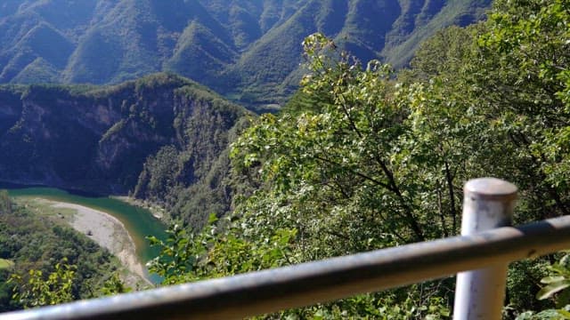 View of a green river winding through lush mountains