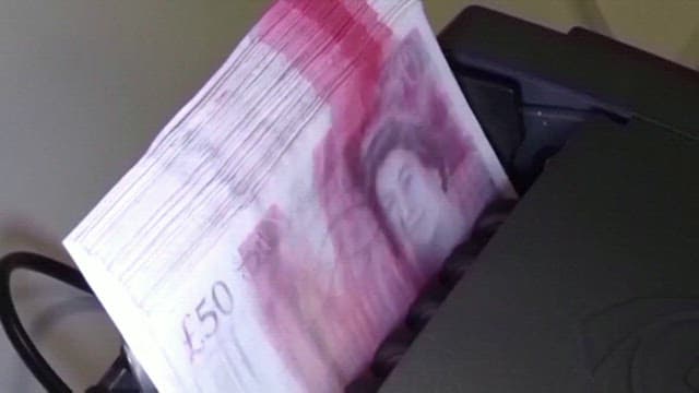 British Pound Currency Being Counted on a Counting Machine of Bank