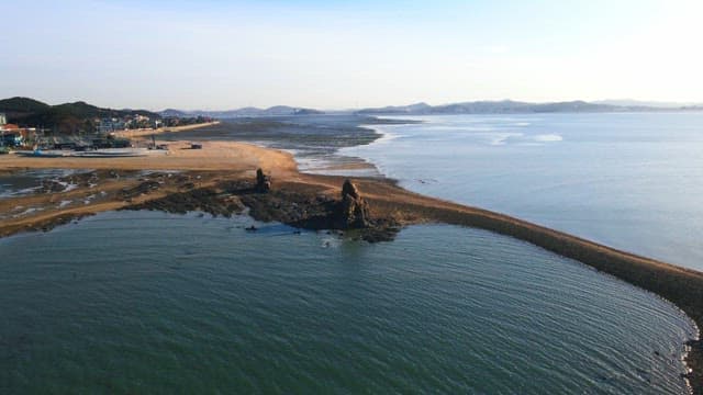 Beach in a coastal town with the tide coming in in the afternoon