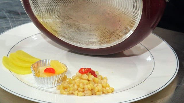 Cheese-filled kimchi fried rice on a plate with corn salad