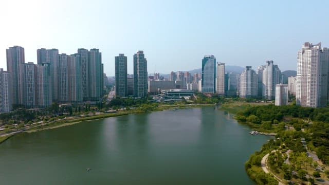 Aerial view of a city with high-rise buildings and a lake