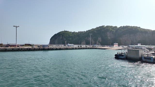 Coastal port at noon with a view of the hills
