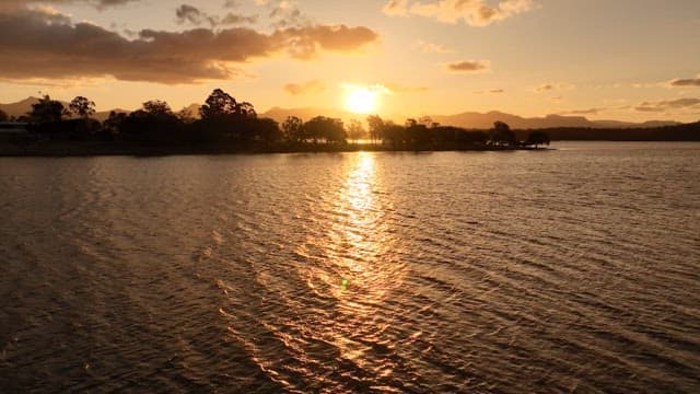 Sunset Over Tranquil Lake with Mountains