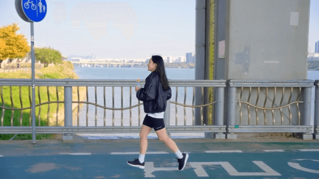 Woman drinking water while jogging