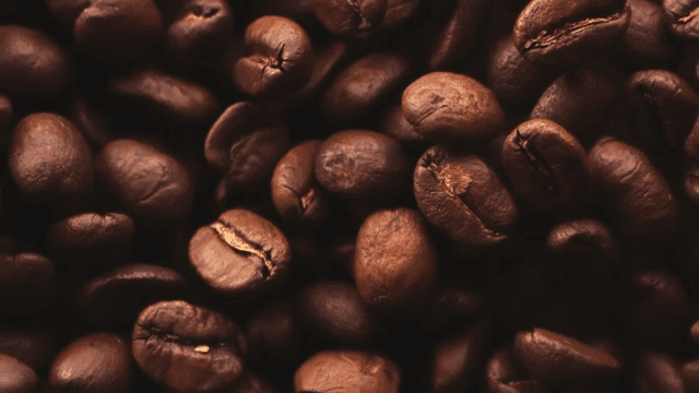 Slow-motion shot of coffee beans scattering