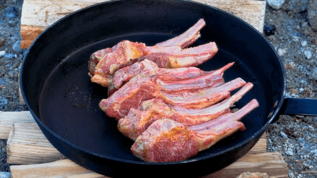 Well-seasoned lamb arranged neatly on a frying pan