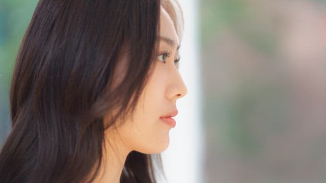 Woman blinking her neatly groomed eyelashes