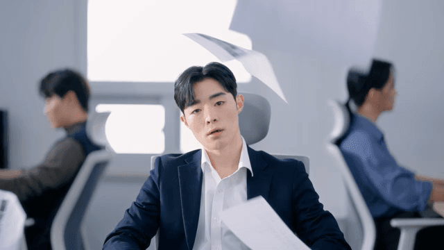 Papers pouring down on a tired man