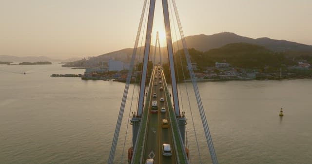 Bridge over water at sunset with traffic