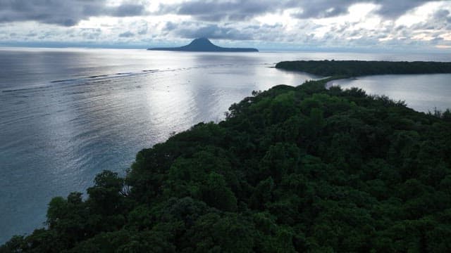 Island at dawn with clouds and ocean