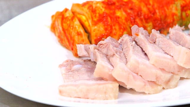 Napa wraps with pork with kimchi on a plate
