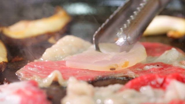 Sizzling beef brisket and scallops on the grill