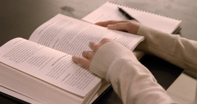 Studious Individual Engaged in Learning with Reading