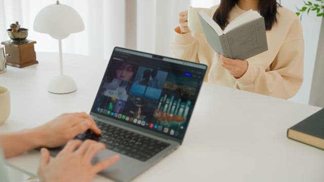 Two people enjoying leisure time at the white table in the living room