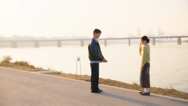 Couple taking pictures at the riverside