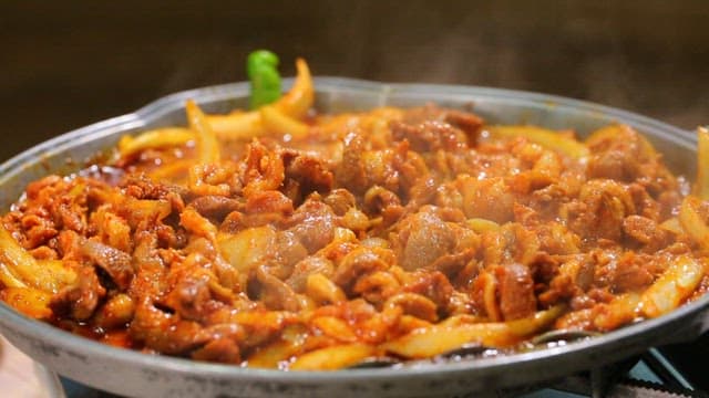 Spicy duck bulgogi sizzling in a pan