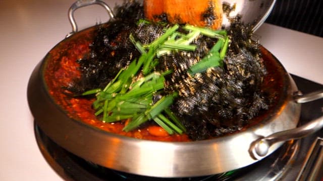 Stir-fried rice with vegetables and seaweed in a pan