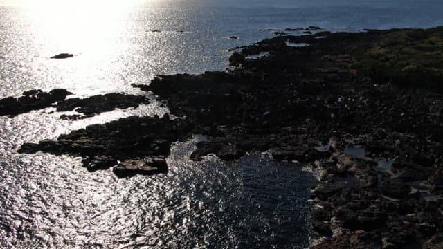 Aerial View of Rocky Coastline Sparkling in Sunlight