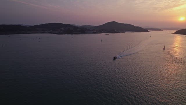Sunset over a calm sea with distant islands