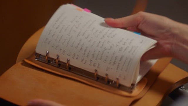 Doctor Looking Through a Diary Dilled with Notes